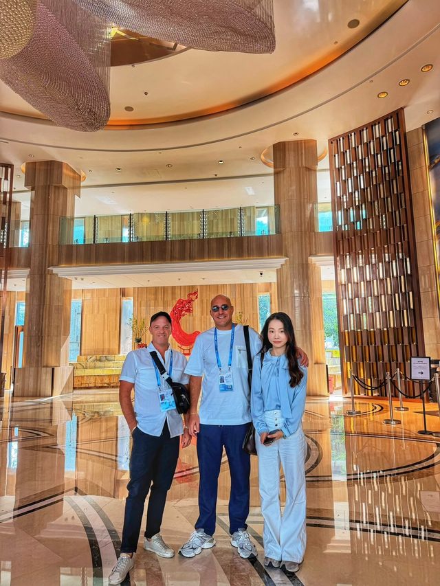 Shirley Chou with two overseas clients in a hotel lobby in Guangzhou
